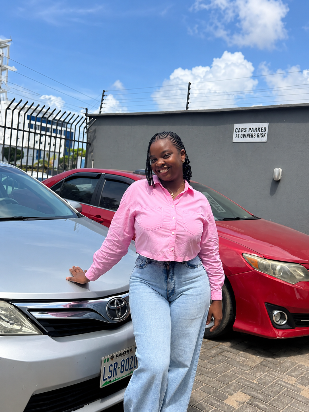 Esther outdoors in a pink shirt